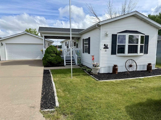 33150 Donna Dr, Prairie Du Chien, WI 53821 - view of front of home featuring an outbuilding, a front yard, and a detached garage
