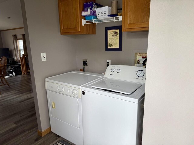 33150 Donna Dr, Prairie Du Chien, WI 53821 - washroom with cabinet space, washer and dryer, dark wood-type flooring, and baseboards