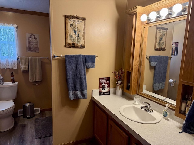 33150 Donna Dr, Prairie Du Chien, WI 53821 - bathroom featuring toilet, vanity, and wood finished floors