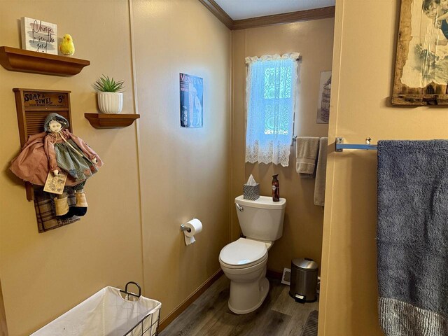 33150 Donna Dr, Prairie Du Chien, WI 53821 - half bath featuring wood finished floors, toilet, ornamental molding, and baseboards