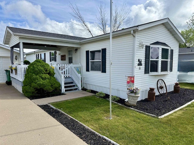 33150 Donna Dr, Prairie Du Chien, WI 53821 - view of front of property with a front yard and a garage