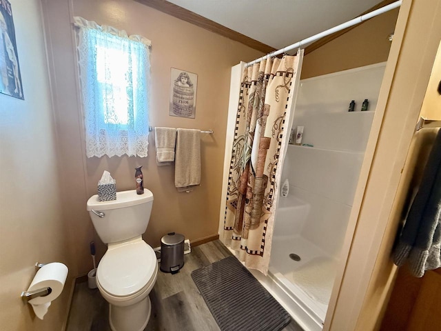 33150 Donna Dr, Prairie Du Chien, WI 53821 - full bath featuring a stall shower, wood finished floors, toilet, and baseboards