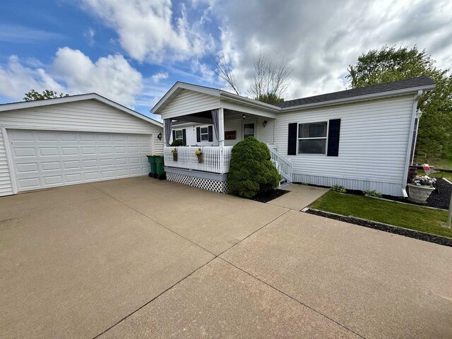 33150 Donna Dr, Prairie Du Chien, WI 53821 - view of front of home featuring a porch, an outbuilding, and a detached garage