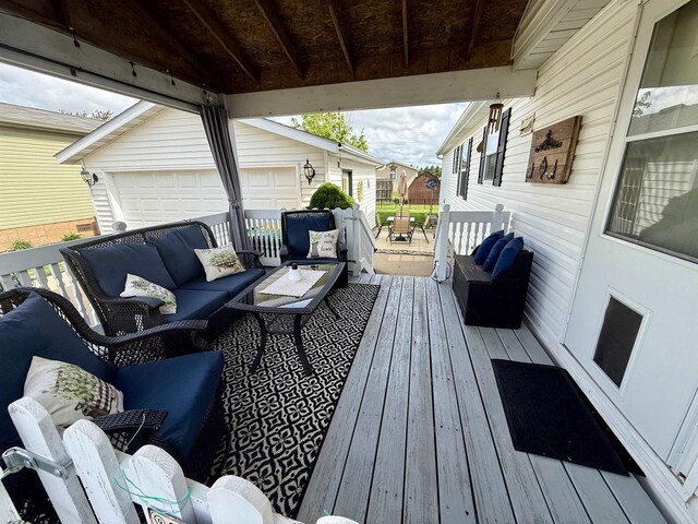 33150 Donna Dr, Prairie Du Chien, WI 53821 - wooden deck featuring an outdoor living space, a garage, and an outbuilding