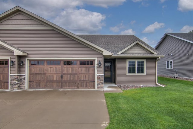 5631 Green Park Dr, Eau Claire, WI 54703 - view of front of house with a front yard, stone siding, a garage, and driveway