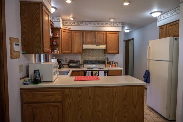 1656 Czech Dr, Friendship, WI 53934 - kitchen featuring white appliances, under cabinet range hood, brown cabinetry, light countertops, and a peninsula