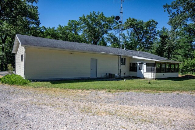 1656 Czech Dr, Friendship, WI 53934 - back of property with a sunroom, a lawn, and central air condition unit