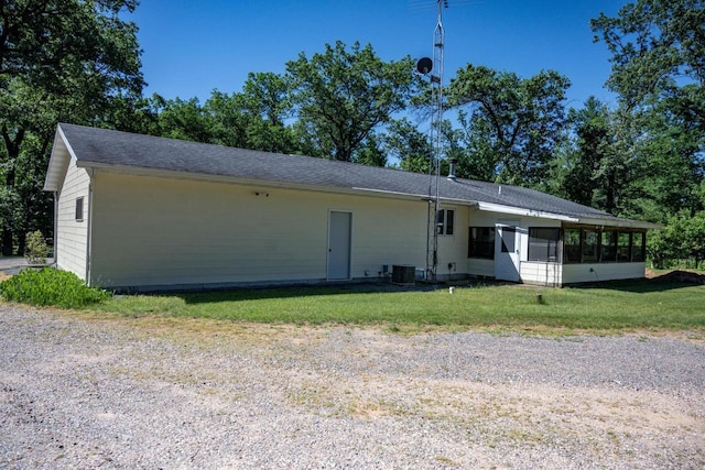 1656 Czech Dr, Friendship, WI 53934 - back of property with a sunroom, a lawn, and central air condition unit