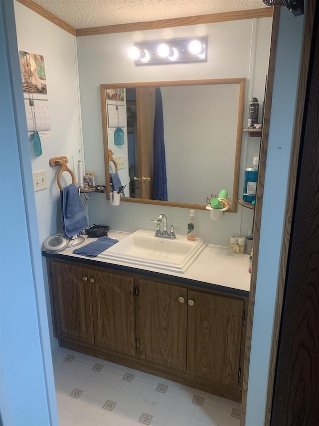39 Douglas St, Westby, WI 54667 - bathroom with vanity, ornamental molding, tile patterned floors, and a textured ceiling