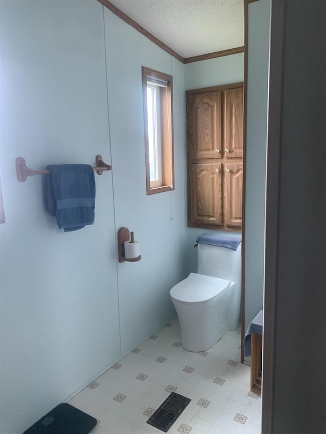 39 Douglas St, Westby, WI 54667 - bathroom with toilet, crown molding, tile patterned floors, and a textured ceiling