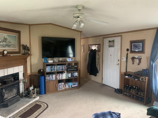 39 Douglas St, Westby, WI 54667 - carpeted living room with ceiling fan, ornamental molding, a wood stove, and vaulted ceiling