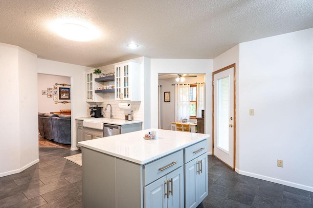 24301 Dexter Ave, Tomah, WI 54660 - kitchen featuring a textured ceiling, a sink, dishwasher, light countertops, and open shelves