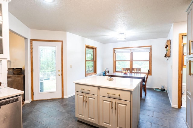 24301 Dexter Ave, Tomah, WI 54660 - kitchen with dishwasher, light countertops, a textured ceiling, a center island, and baseboards