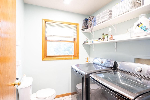 24301 Dexter Ave, Tomah, WI 54660 - washroom featuring separate washer and dryer, light tile patterned floors, and baseboards