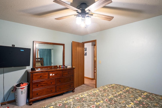 24301 Dexter Ave, Tomah, WI 54660 - bedroom with light carpet, a textured ceiling, and a ceiling fan