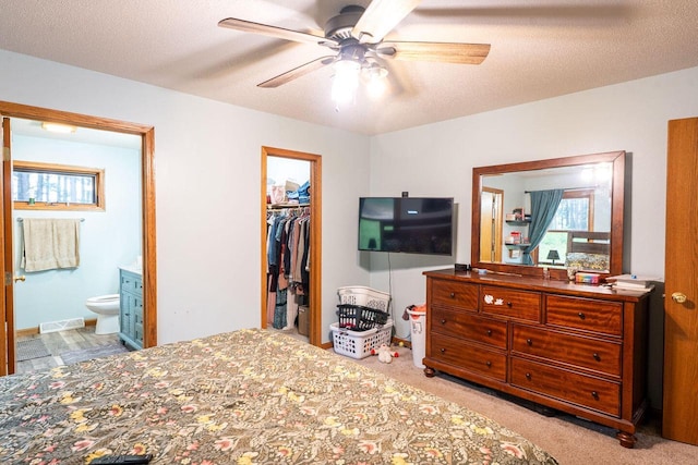 24301 Dexter Ave, Tomah, WI 54660 - bedroom with ensuite bathroom, a closet, a walk in closet, carpet floors, and a ceiling fan