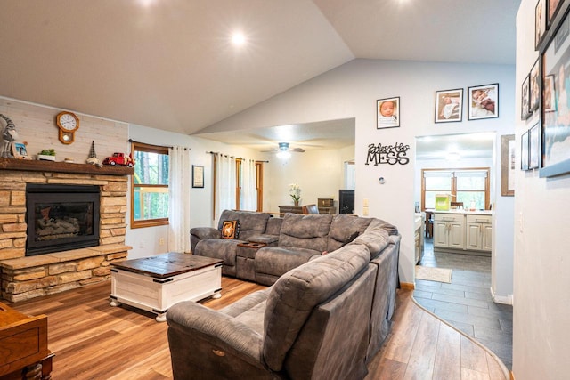 24301 Dexter Ave, Tomah, WI 54660 - living room with hardwood / wood-style floors, a fireplace, healthy amount of natural light, and high vaulted ceiling