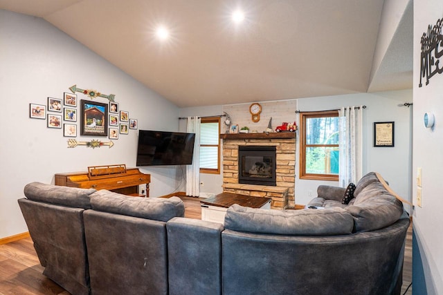 24301 Dexter Ave, Tomah, WI 54660 - living area featuring lofted ceiling, wood finished floors, baseboards, and a fireplace