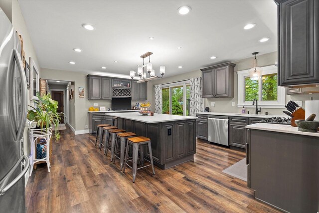 8445 S 44th St, Franklin, WI 53132 - kitchen featuring stainless steel appliances, a kitchen island, healthy amount of natural light, light countertops, and recessed lighting