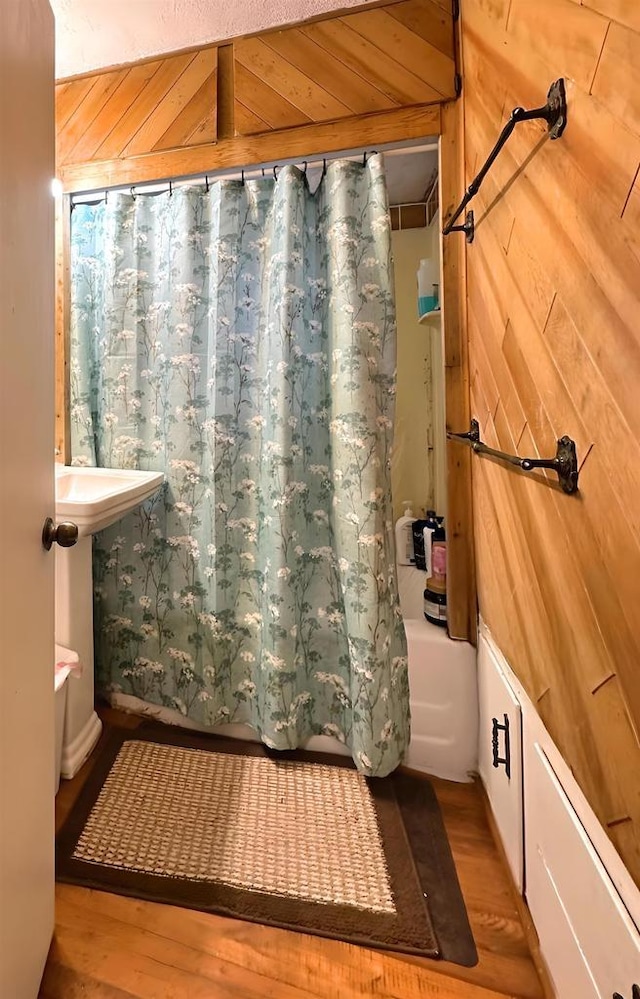 1340 Liberty St, Oshkosh, WI 54901 - bathroom with wood finished floors and shower / bath combo