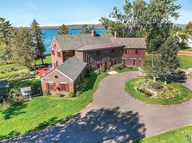 933 Nebraska Row, La Pointe, WI 54850 - view of front of property featuring curved driveway, a water view, and a chimney