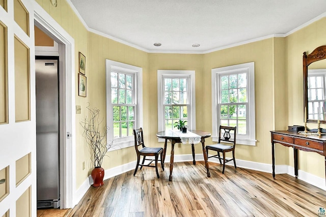 933 Nebraska Row, La Pointe, WI 54850 - dining space featuring crown molding, light wood-style flooring, and baseboards
