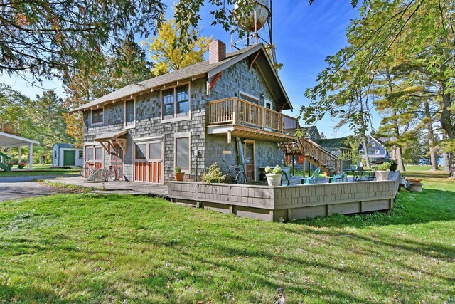 933 Nebraska Row, La Pointe, WI 54850 - rear view of property with a chimney, a lawn, a deck, and a shingled roof