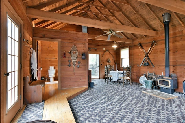 933 Nebraska Row, La Pointe, WI 54850 - miscellaneous room with wooden walls, a wood stove, a ceiling fan, and wood ceiling