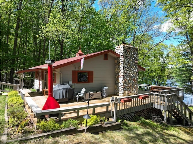 12272 Ewig Rd, Hayward, WI 54843 - rear view of property with a chimney and a wooden deck