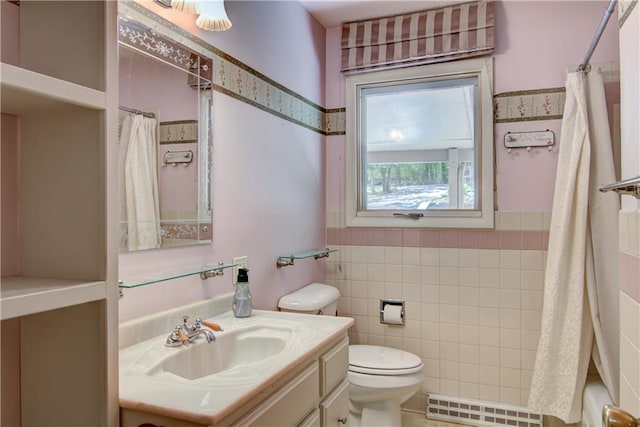 12272 Ewig Rd, Hayward, WI 54843 - bathroom featuring tile walls, toilet, vanity, a wainscoted wall, and shower / bath combination with curtain