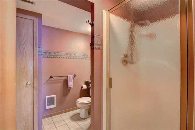 12272 Ewig Rd, Hayward, WI 54843 - bathroom featuring heating unit, toilet, a shower stall, and tile patterned floors