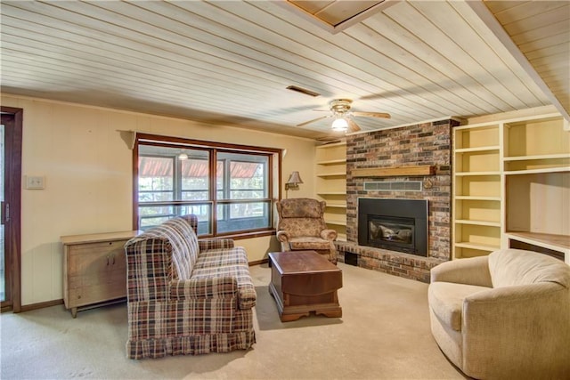 12272 Ewig Rd, Hayward, WI 54843 - carpeted living area with wood ceiling, baseboards, a fireplace, a ceiling fan, and built in features