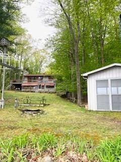 12272 Ewig Rd, Hayward, WI 54843 - view of green lawn with a detached garage