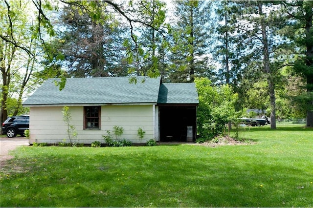 915 W Knapp St, Rice Lake, WI 54868 - view of side of property with roof with shingles and a lawn