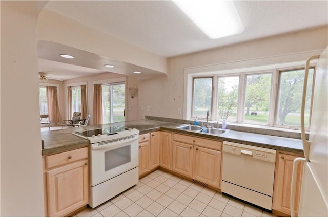915 W Knapp St, Rice Lake, WI 54868 - kitchen featuring white appliances, a sink, light brown cabinetry, light tile patterned floors, and a peninsula