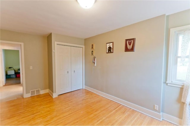 915 W Knapp St, Rice Lake, WI 54868 - unfurnished bedroom featuring light wood finished floors, a closet, and baseboards