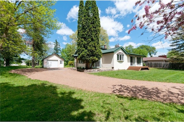 915 W Knapp St, Rice Lake, WI 54868 - view of side of home with a garage, an outbuilding, stucco siding, and dirt driveway