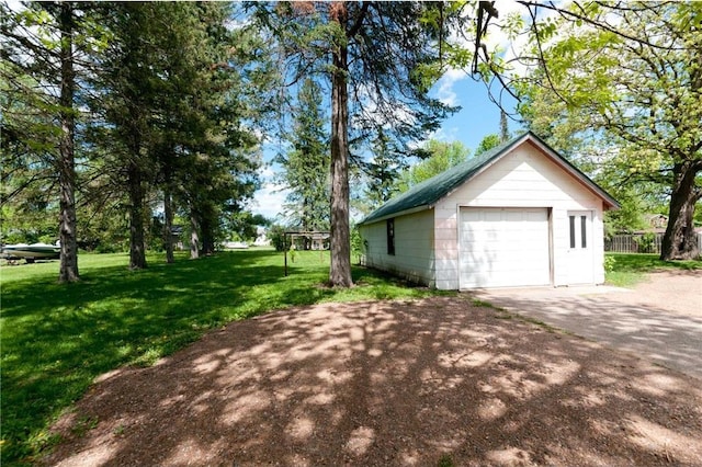 915 W Knapp St, Rice Lake, WI 54868 - view of home's exterior with asphalt driveway, a detached garage, and an outbuilding