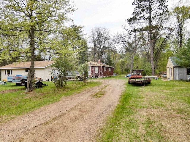 W8666 County Rd K, Elcho, WI 54428 - view of dirt / gravel driveway featuring view of wooded area