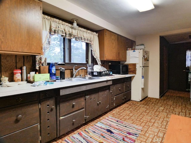 W8666 County Rd K, Elcho, WI 54428 - kitchen featuring freestanding refrigerator, a sink, black microwave, light countertops, and dark brown cabinets