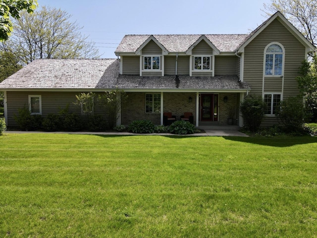 11616 N Lantern Ln, Mequon, WI 53092 - traditional home featuring a front yard, brick siding, and a porch