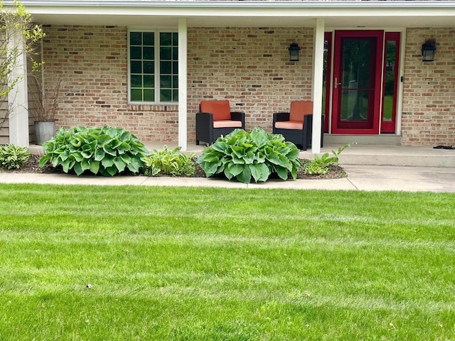 11616 N Lantern Ln, Mequon, WI 53092 - property entrance with a yard, covered porch, and brick siding