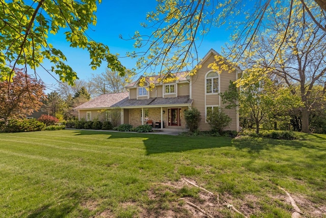 11616 N Lantern Ln, Mequon, WI 53092 - traditional-style house with a front lawn, a porch, and brick siding