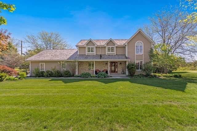 11616 N Lantern Ln, Mequon, WI 53092 - traditional-style home featuring brick siding, a front lawn, and a porch