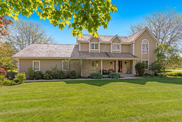 11616 N Lantern Ln, Mequon, WI 53092 - traditional-style home featuring a front lawn, brick siding, and covered porch