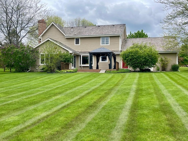 11616 N Lantern Ln, Mequon, WI 53092 - back of house featuring a gazebo, a chimney, and a lawn
