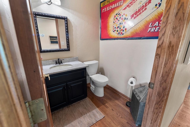 11616 N Lantern Ln, Mequon, WI 53092 - half bath featuring toilet, wood finished floors, vanity, and baseboards
