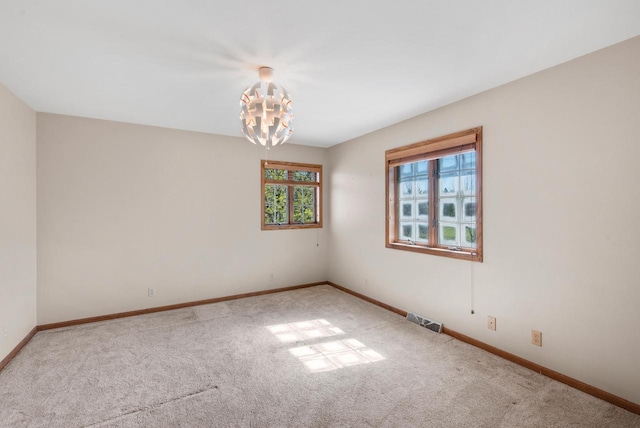 11616 N Lantern Ln, Mequon, WI 53092 - spare room featuring carpet floors, a chandelier, and baseboards