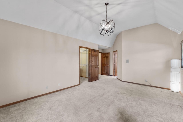 11616 N Lantern Ln, Mequon, WI 53092 - spare room featuring lofted ceiling, light colored carpet, baseboards, and a chandelier