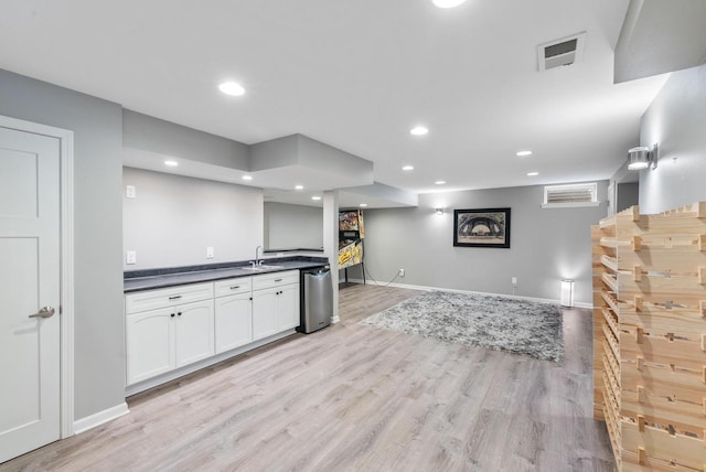 11616 N Lantern Ln, Mequon, WI 53092 - indoor bar featuring light wood-style flooring, baseboards, recessed lighting, and stainless steel dishwasher